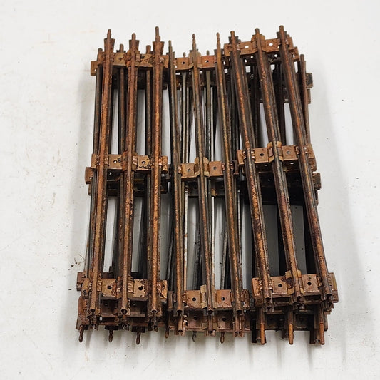 Eleven Lionel O-27 gauge straight metal train tracks with silver ties and rust