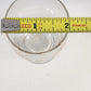 Clear glass container with a yellow Stanley measuring tape on a white background