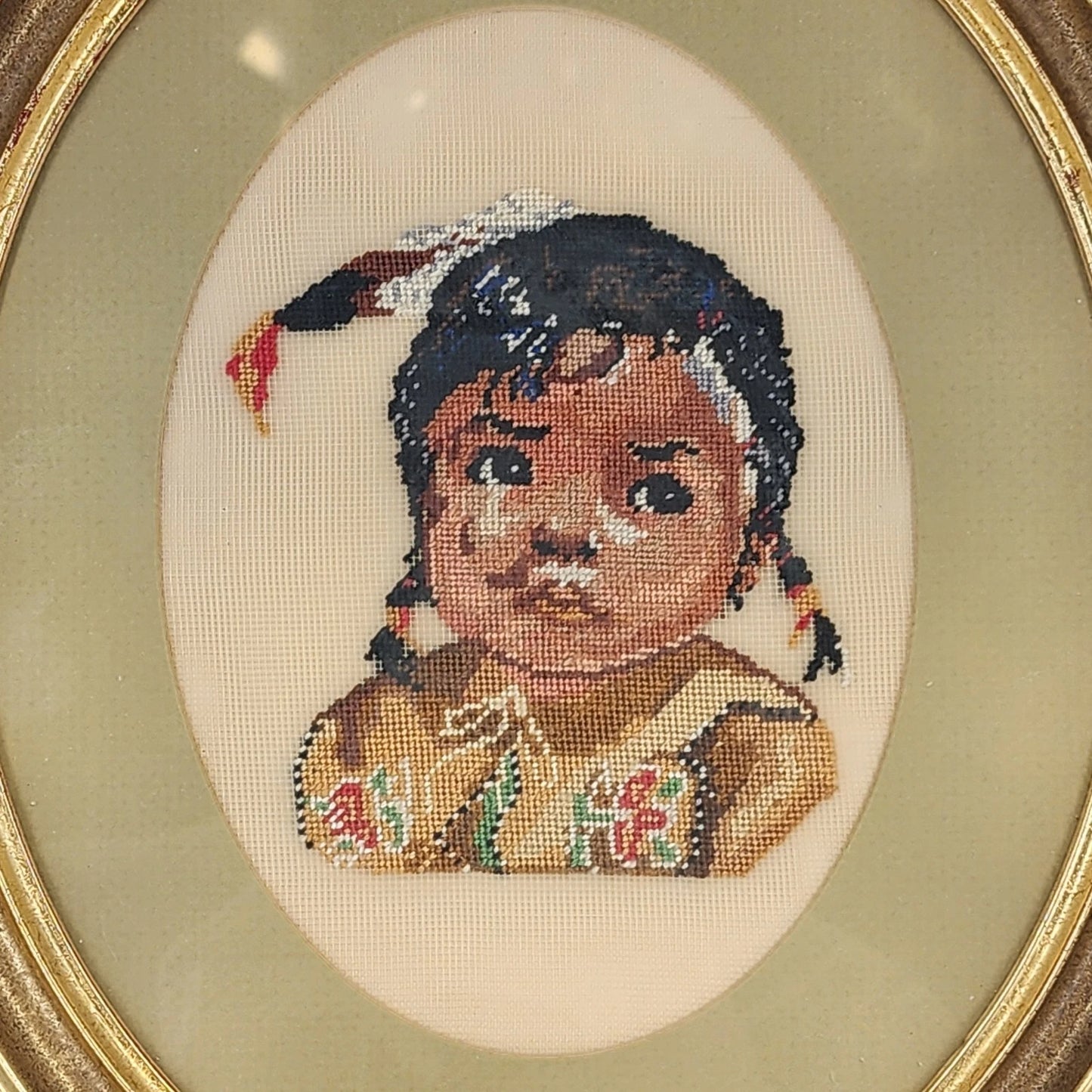 Vintage framed needlepoint portrait of Native American girl in oval wood frame