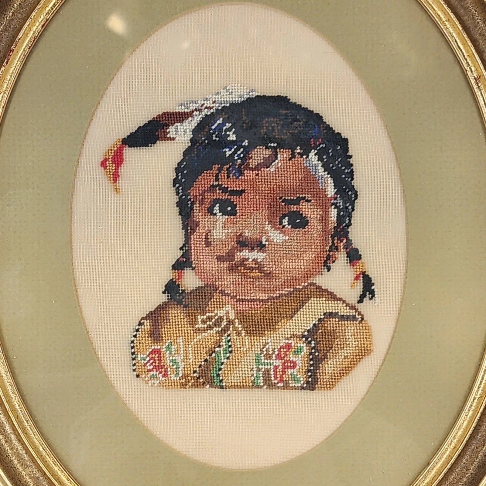 Vintage framed needlepoint portrait of Native American girl in oval wood frame