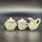 Mini cream porcelain tea set with floral details, creamer, sugar bowl and cup