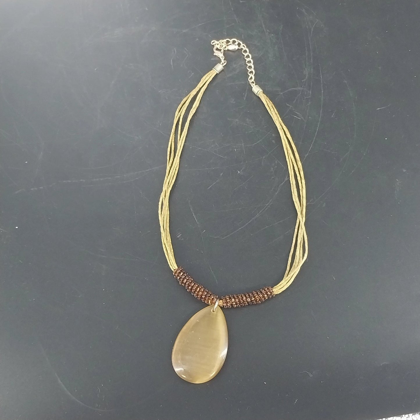 Linea Pele Brushed Gold Teardrop Pendant Necklace With Multi Strand Brown Cord
