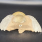 Decorative angel wall sconce with wings on a dark background