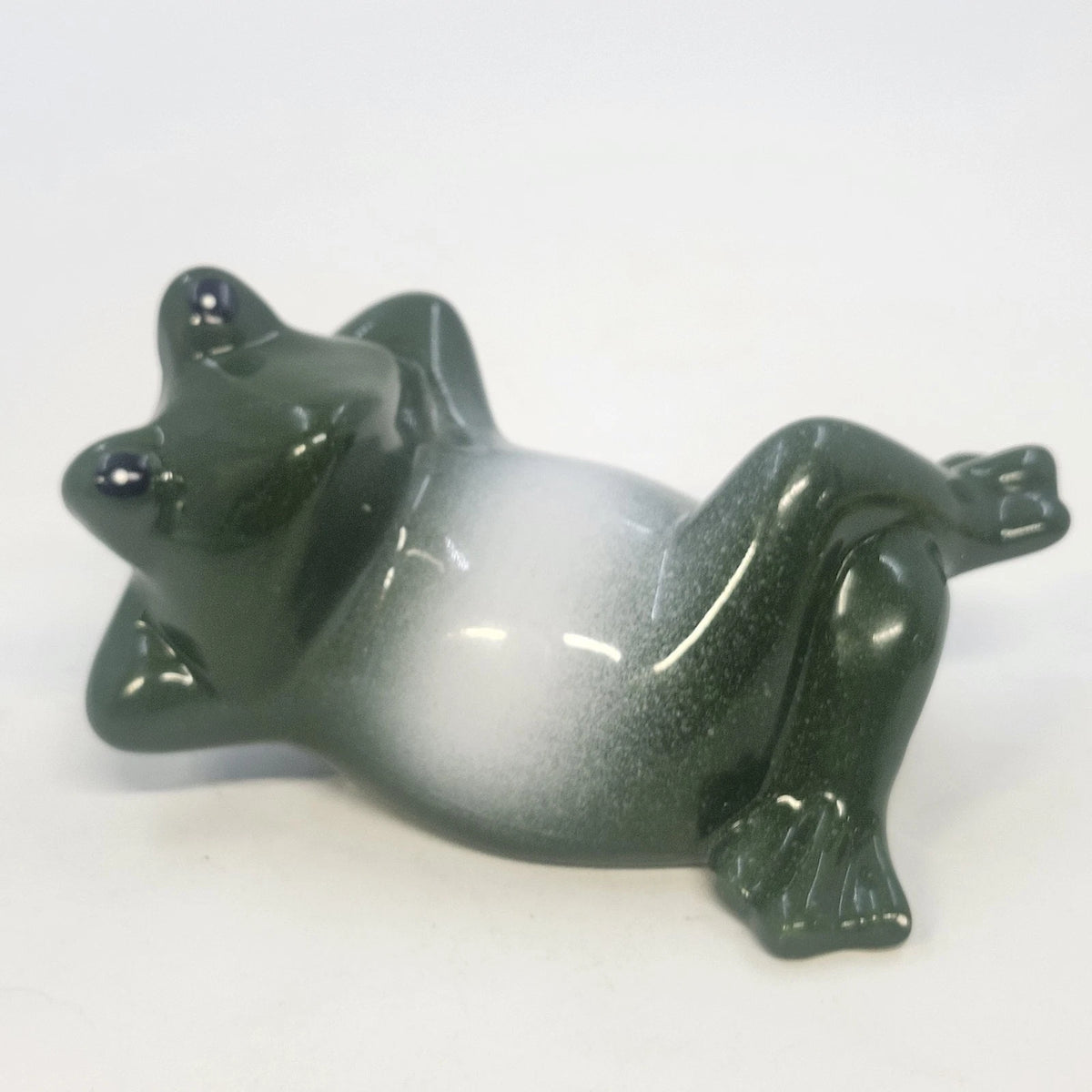 4-inch glossy ceramic frog figurine in a reclining lounging pose