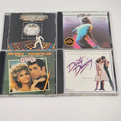 Four classic movie soundtrack CDs including Dirty Dancing and Grease