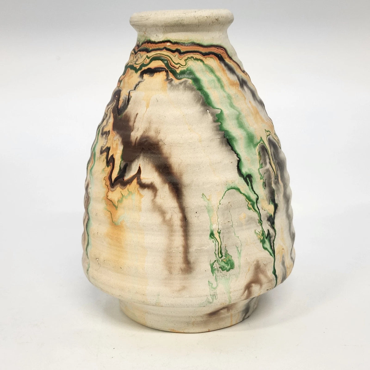 Vintage Nemadji pottery vase with green orange black and brown swirl pattern