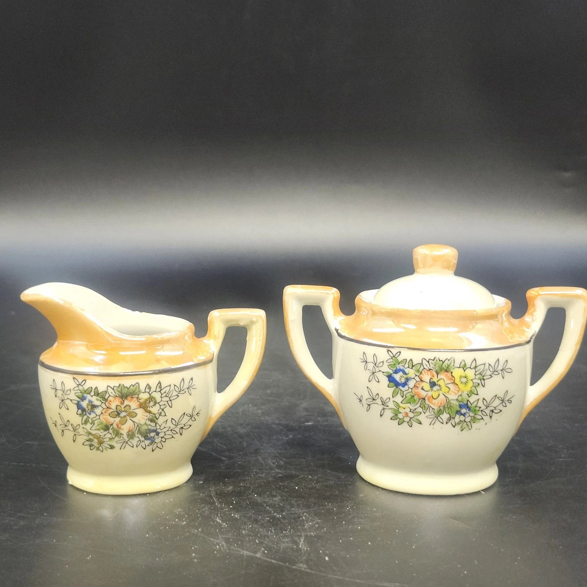 Vintage Japan porcelain creamer and covered sugar bowl with floral design and gold trim