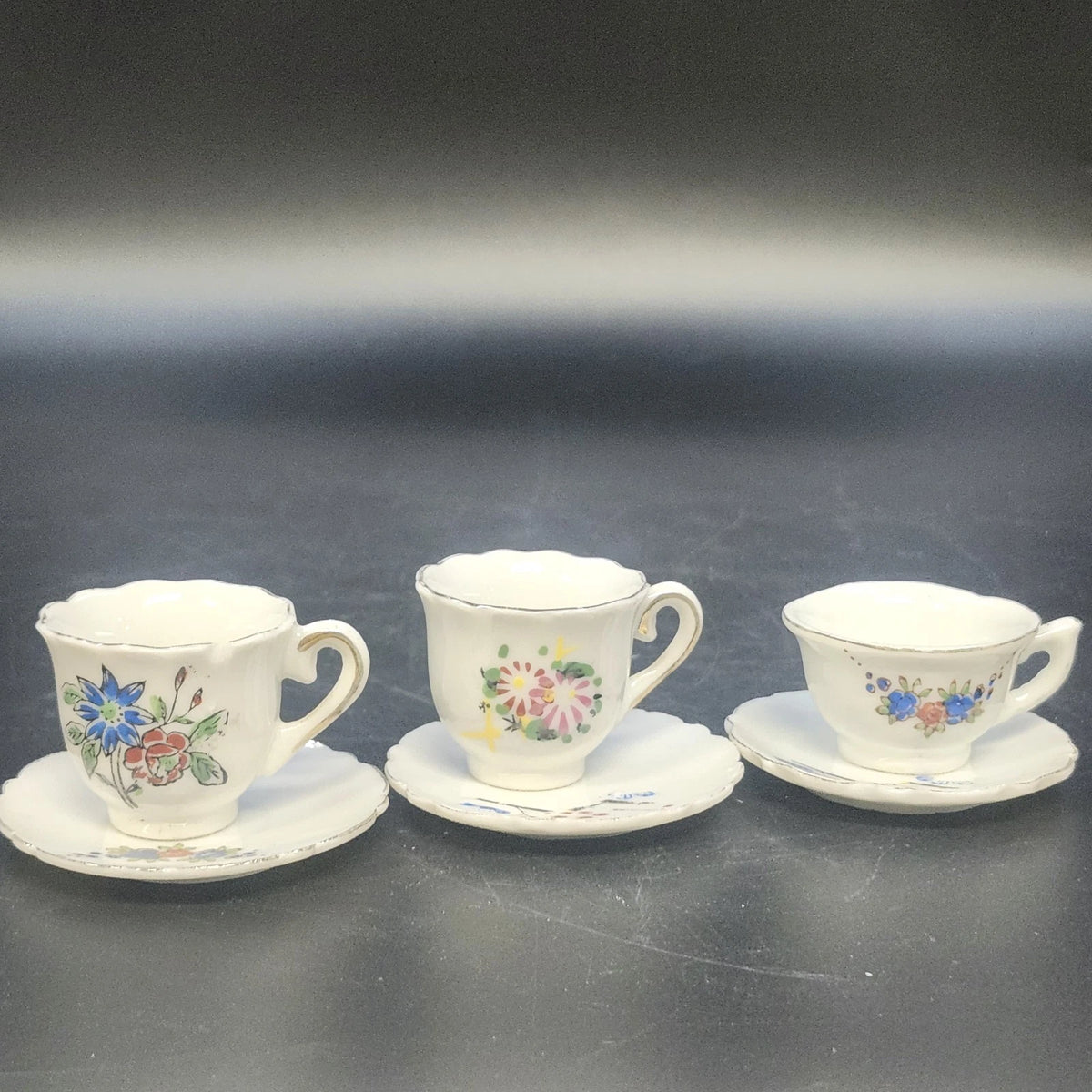 Set of three vintage Japan porcelain demitasse cups with floral saucers