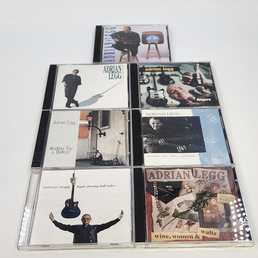 Seven Adrian Legg guitar music CDs with original cover artwork and jewel cases.