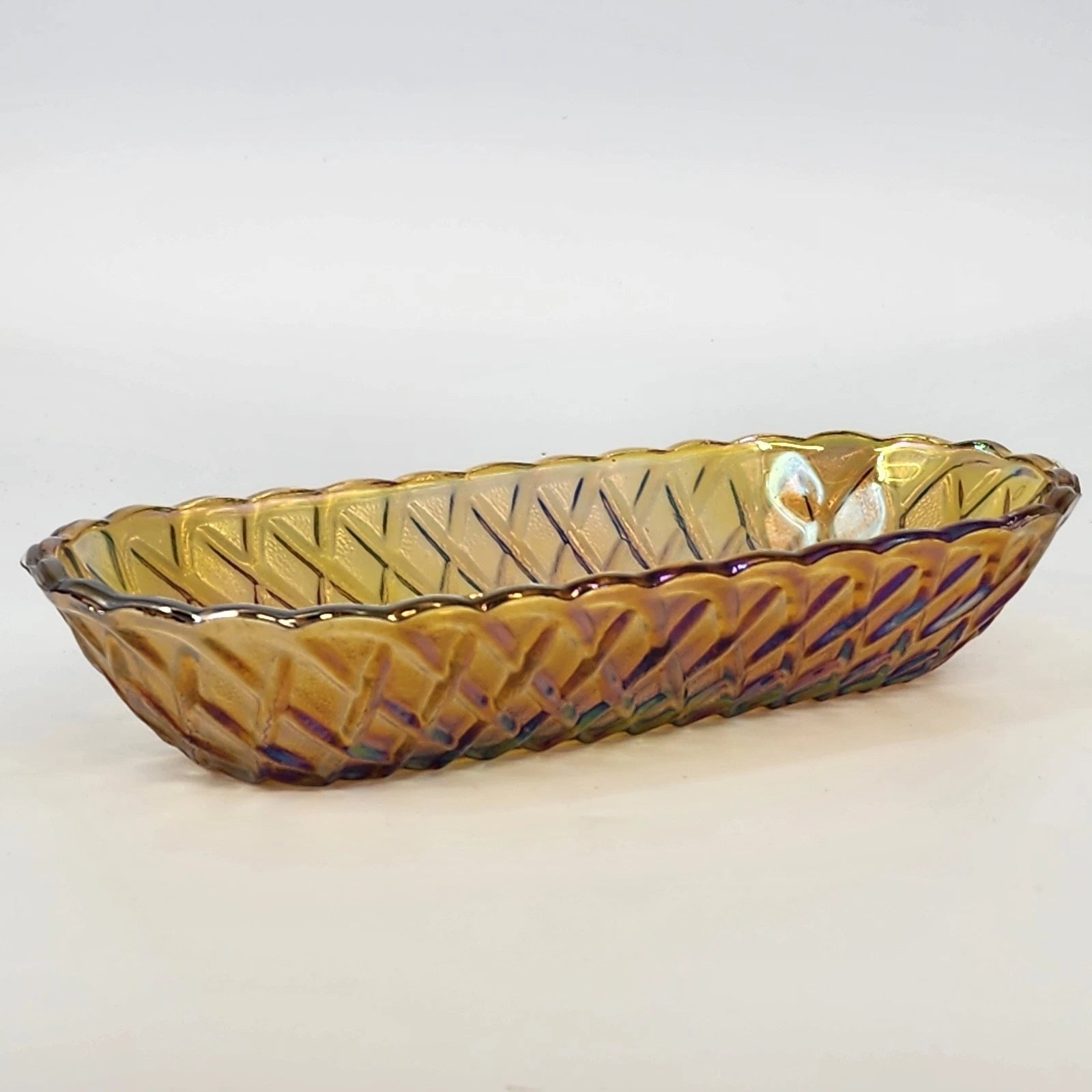Amber iridescent carnival glass oval serving bowl with scalloped edge