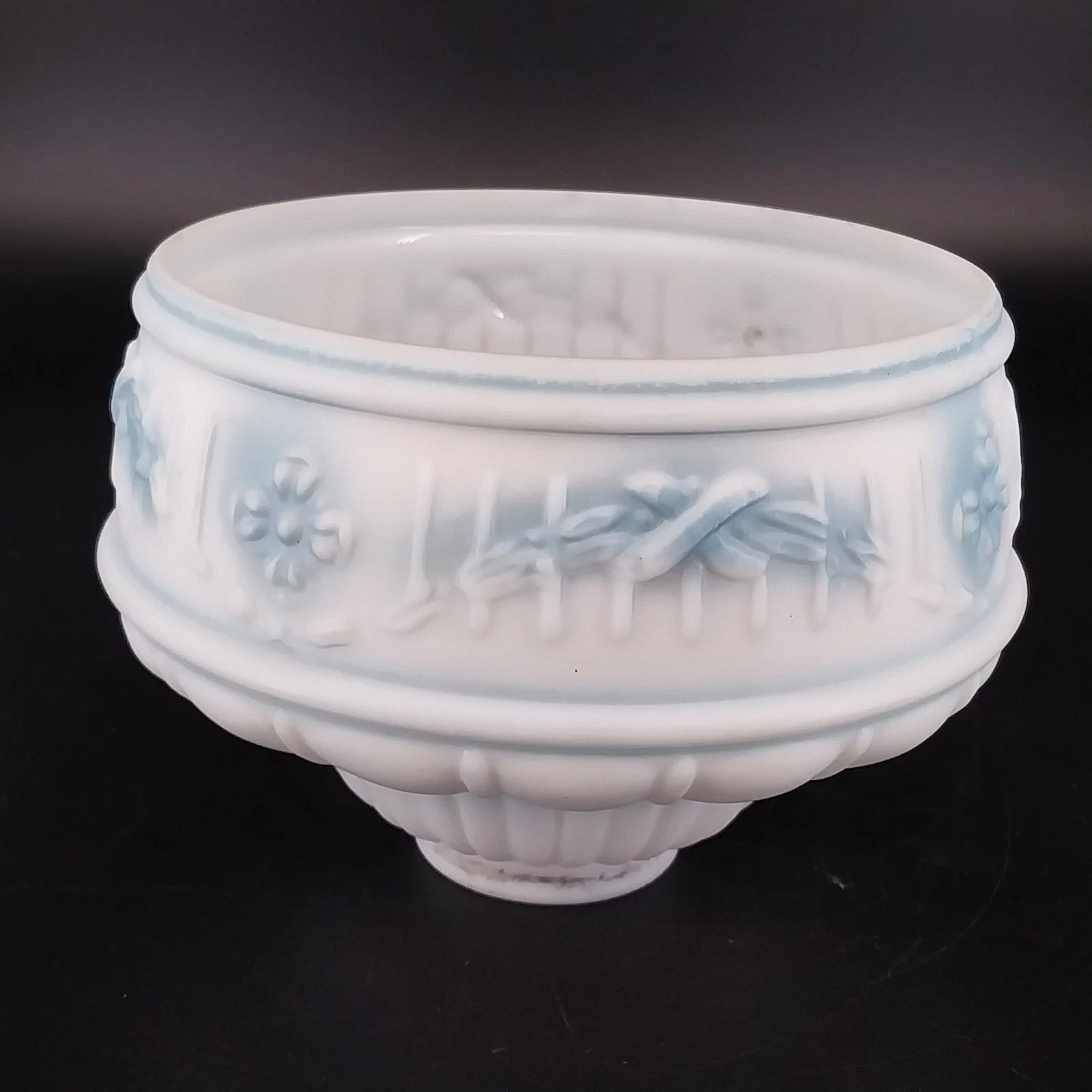 Frosted milk glass lamp shade with blue floral accents and embossed design