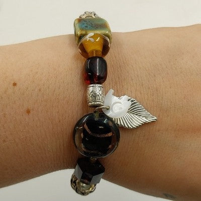 Avon brown beaded stretch bracelet with elephant and leaf charms