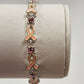 Avon pink enamel ribbon bracelet with sparkling rhinestone accents
