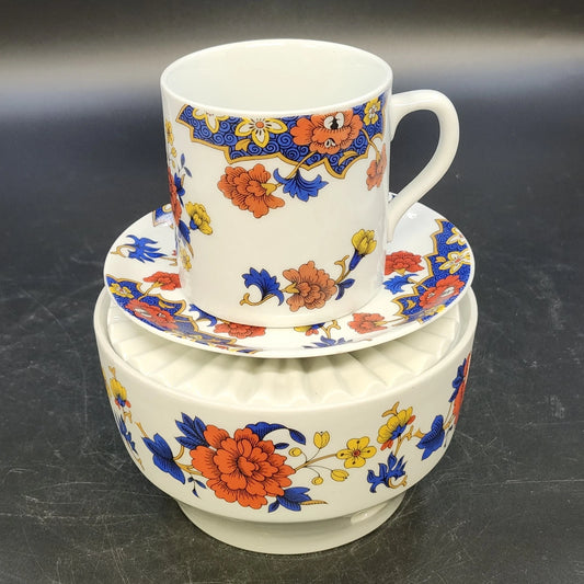 Vintage Bavaria Germany porcelain cup, saucer, and candle warmer with colorful floral pattern.