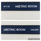 Blue sliding meeting room sign in use vacant