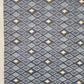 Long blue upholstered table runner with tan geometric cell pattern