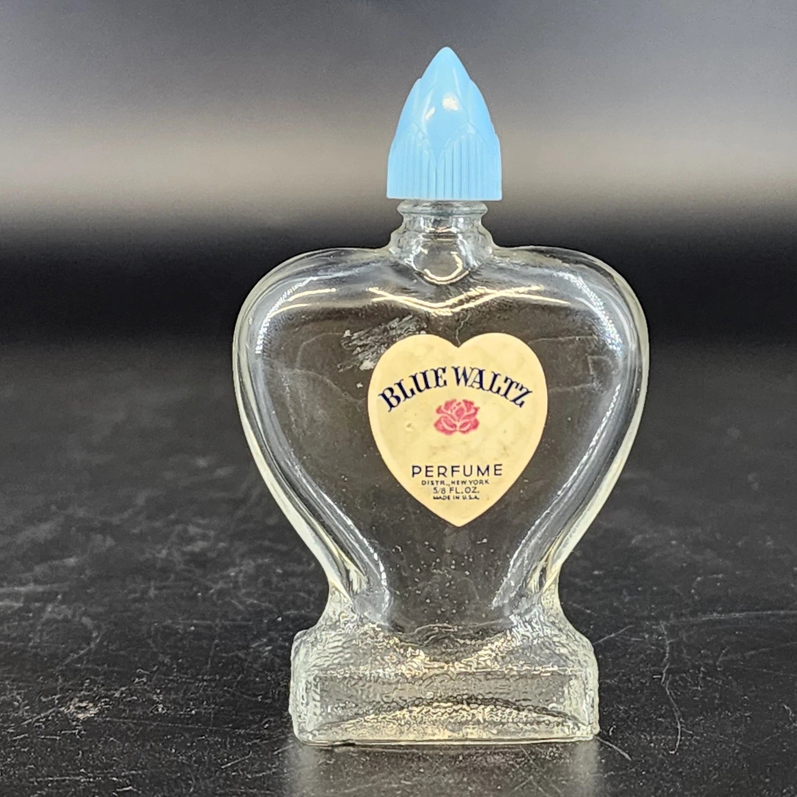 Vintage Blue Waltz heart shaped perfume bottle with blue lid
