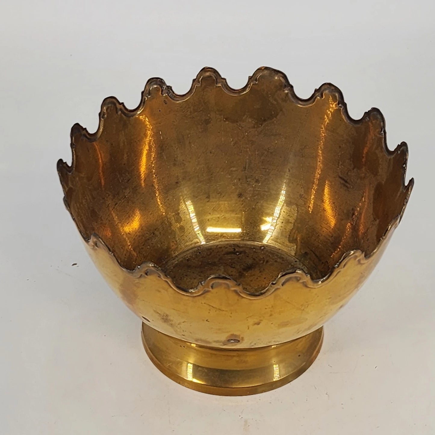 Vintage brass pedestal bowl with scalloped crown rim and raised base