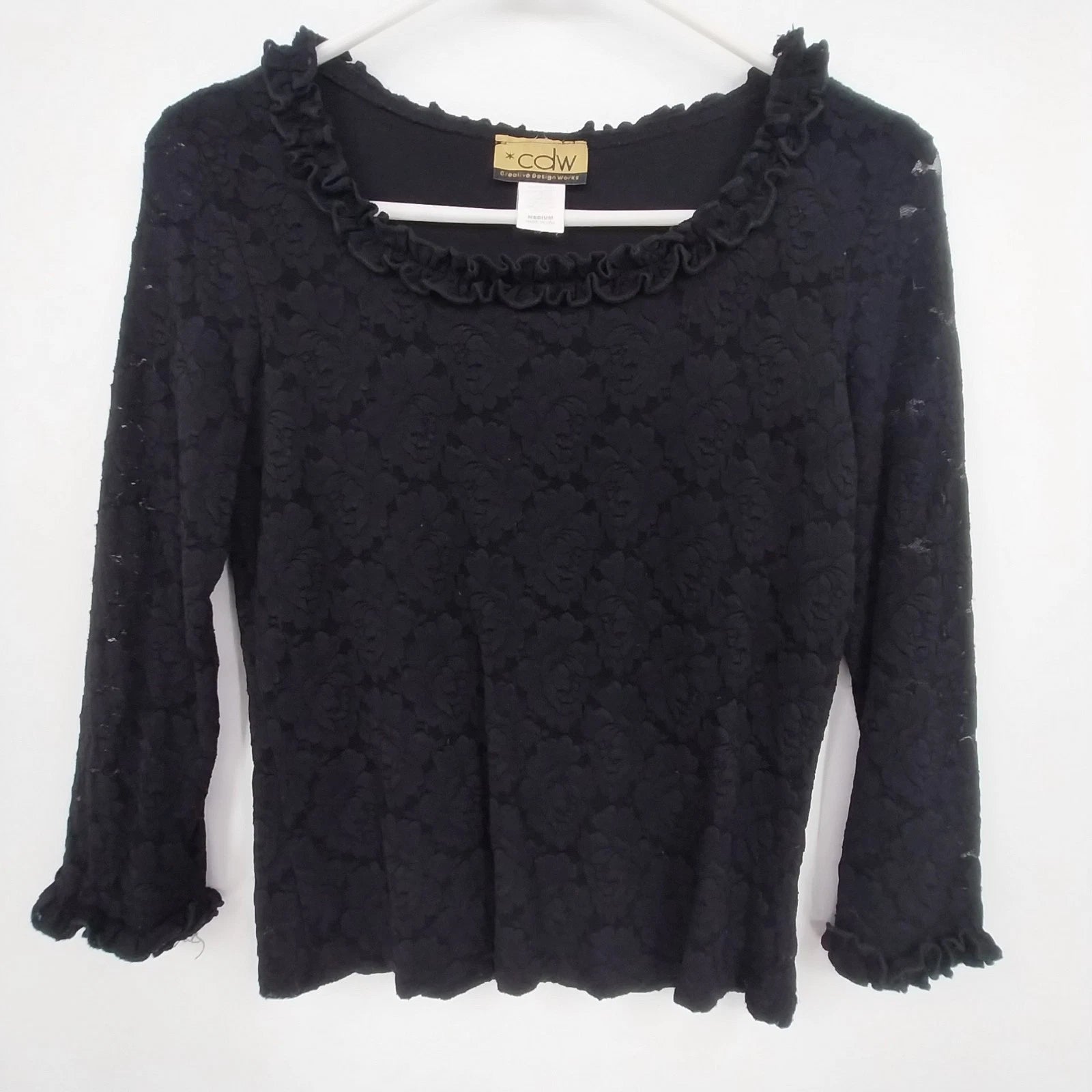 Black floral rose long sleeve top with lace trim and ruffle neckline
