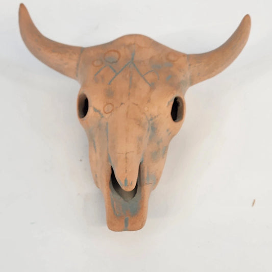 Colorful handcrafted ceramic bull skull figurine with orange and blue glaze