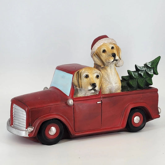 Golden Retriever puppies in red pickup truck with Christmas tree