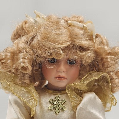 13 inch porcelain doll with blonde curly hair and display stand