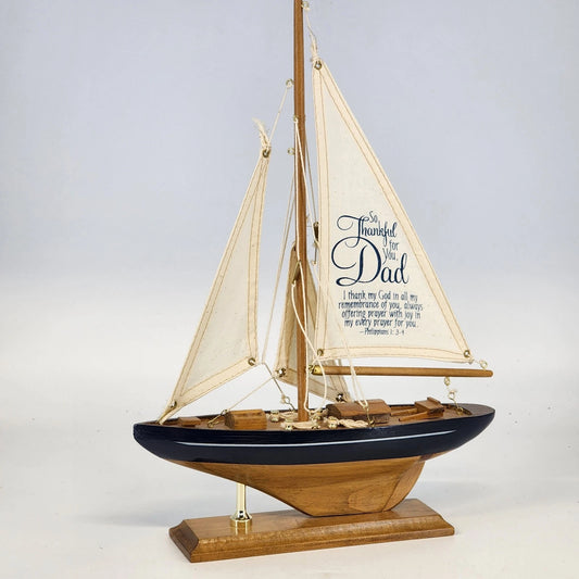 Wooden sailboat decor with white sails and Dad thankful quote