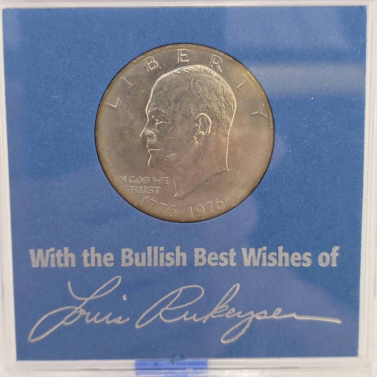 1976 Eisenhower Bicentennial dollar coin in blue commemorative Louis Rukeyser holder