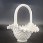 White glass basket with textured design on a dark background