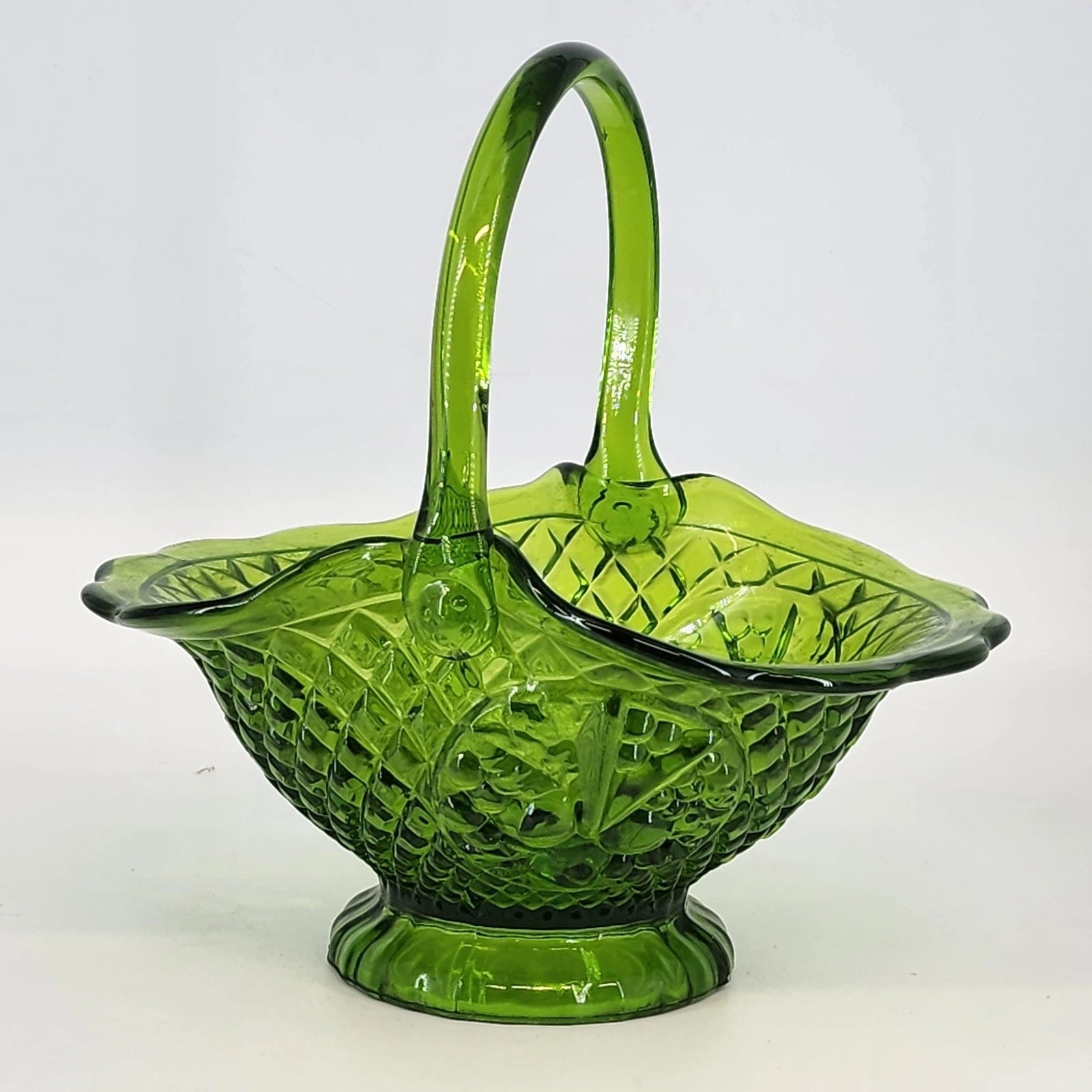 Vintage Fenton green glass basket with ruffled edge and handle