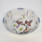 Decorative ceramic bowl with floral design on a white background