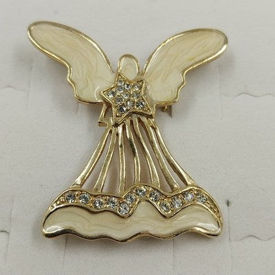 Gold tone open work angel brooch with white enamel and clear rhinestones