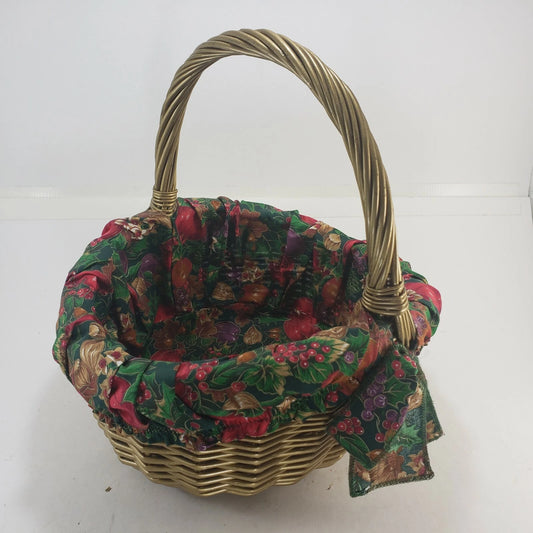 Gold oval wicker basket with removable holiday fabric liner and handles