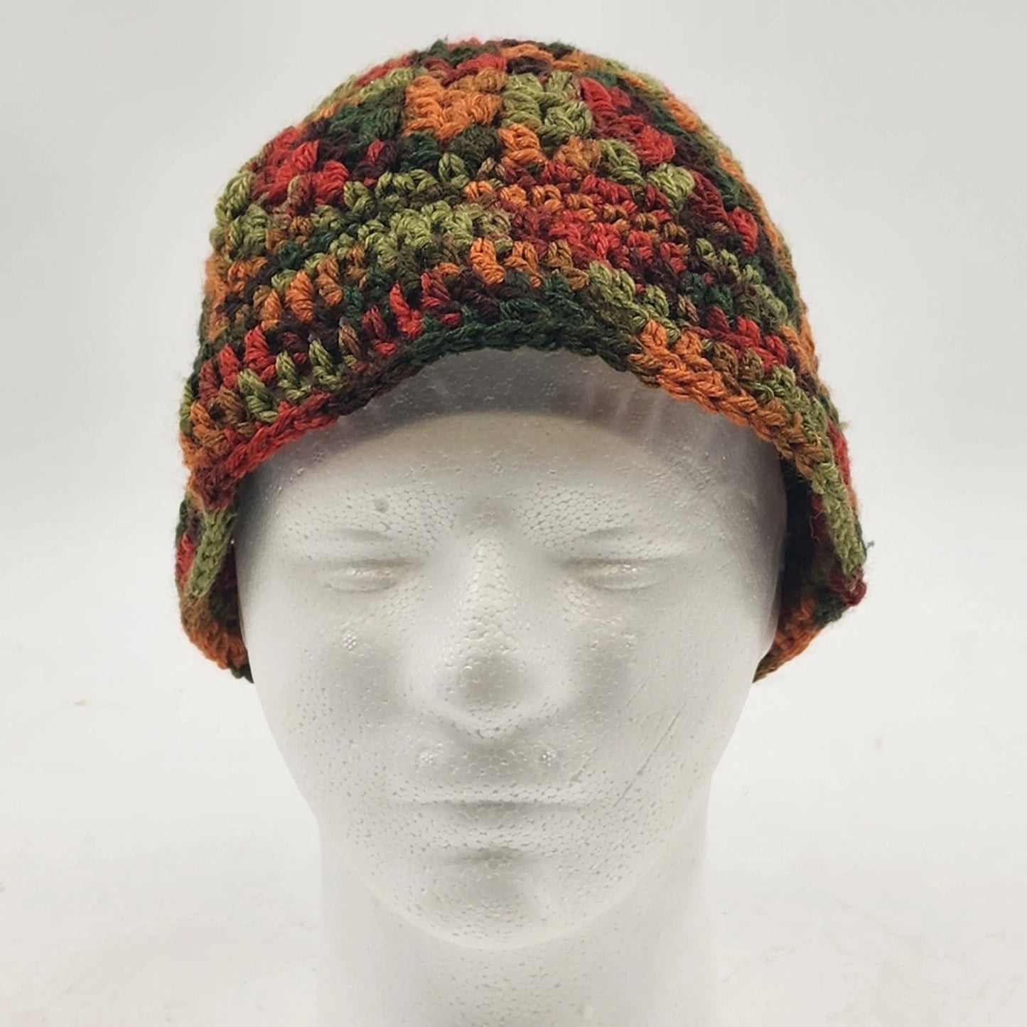 Handmade crochet messy bun beanie in green brown orange fall colors