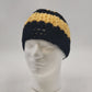 Handmade crochet messy bun beanie with black yellow striped design