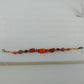 Handmade 8 inch bracelet with orange glass millefiori beads and crystal accents
