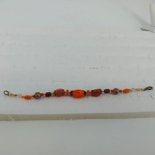 Handmade 8 inch bracelet with orange glass millefiori beads and crystal accents