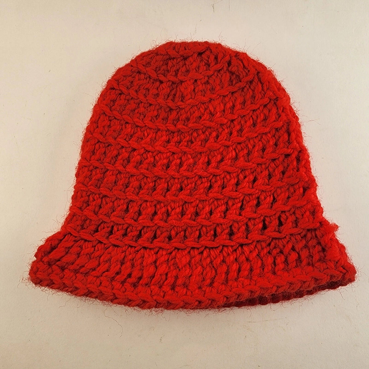 Handmade red crochet hat style toilet paper roll cover for holiday bathroom decor