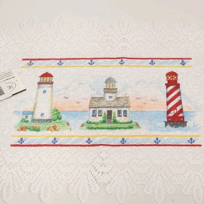 Set of two white Heritage Lace placemats with nautical lighthouse design