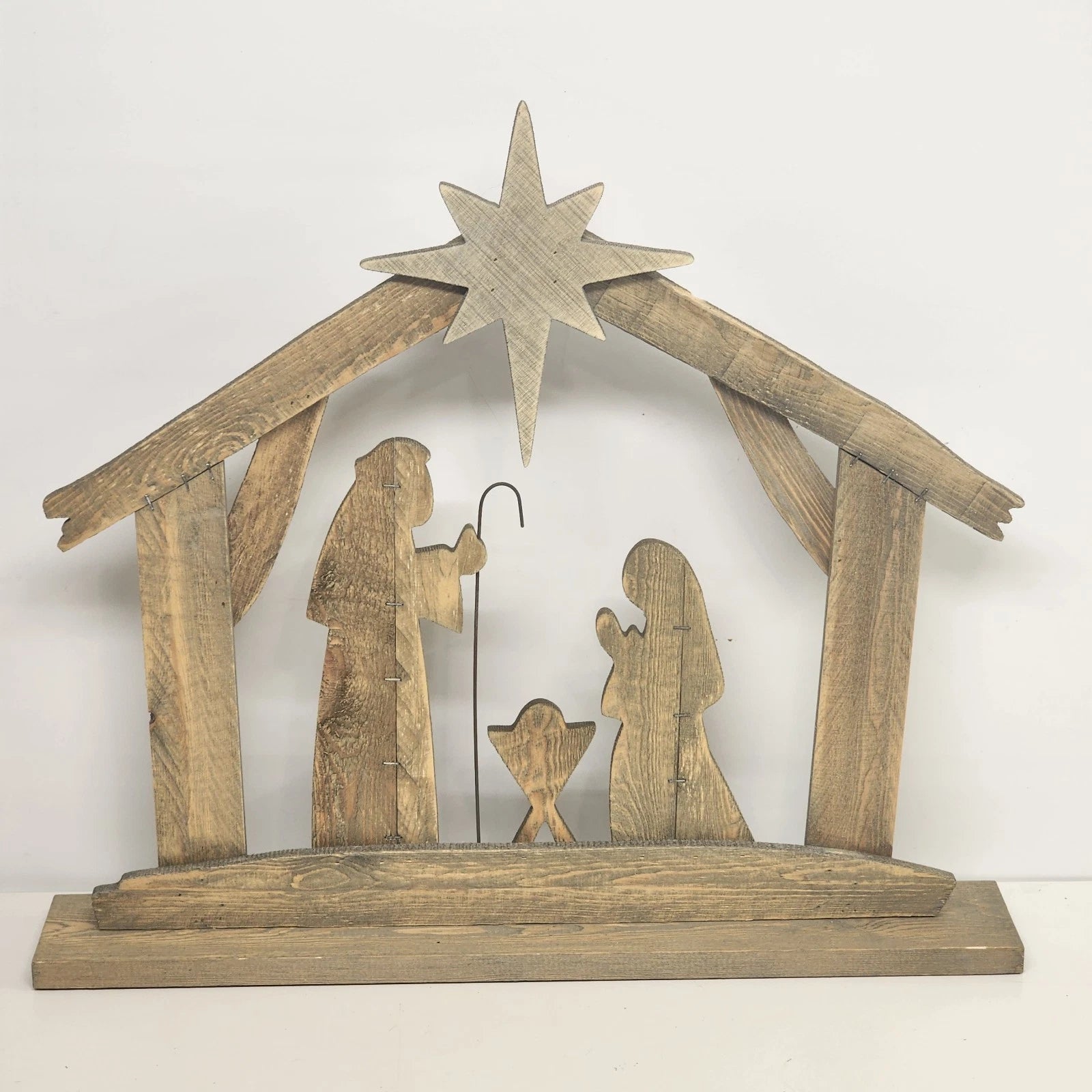 Rustic wood nativity silhouette with Joseph Mary and baby Jesus