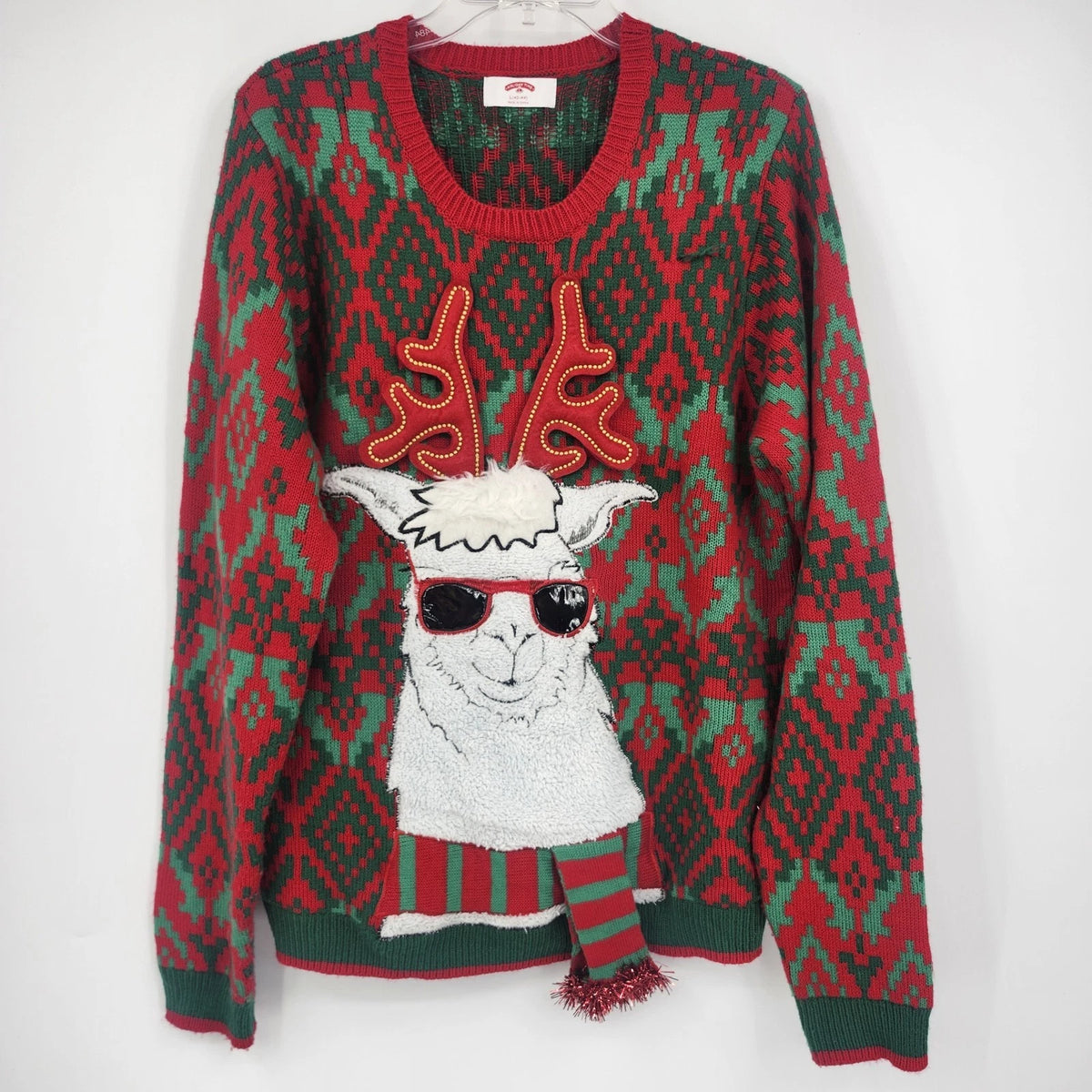 Red and green Holiday Time Christmas sweater with a 3D llama, sunglasses, antlers, and scarf.