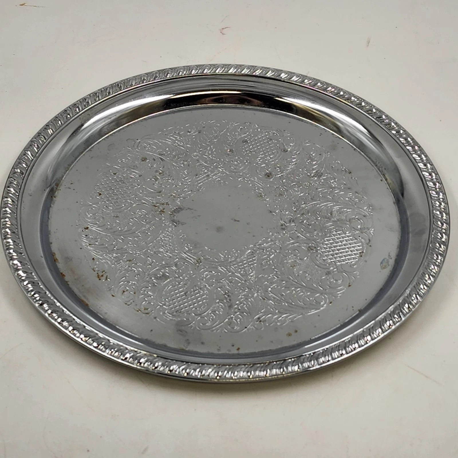 Irvinware silver plated round serving tray with etched scroll design