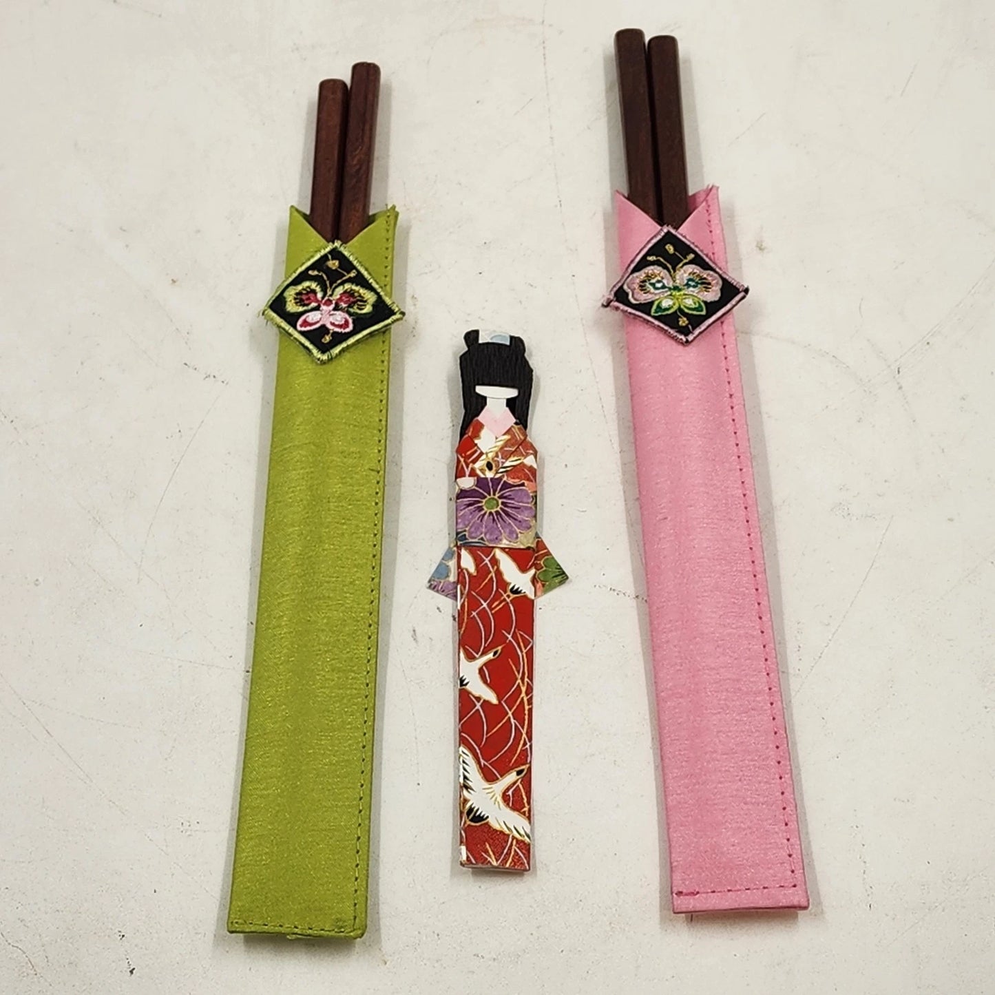 Japanese wooden chopsticks with kokeshi doll rests and embroidered fabric pouch set