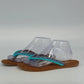 Mad Love brown thong sandals with turquoise pom pom accents