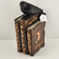Martha Stewart Halloween figurine with black raven on stack of spell books
