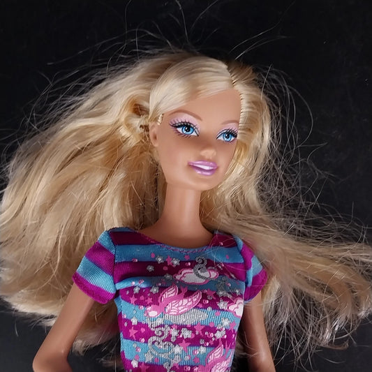 Mattel Barbie babysitter doll with blonde hair and striped dress