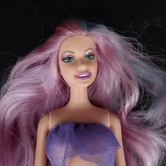 Mattel Barbie mermaid doll with purple hair and glitter top