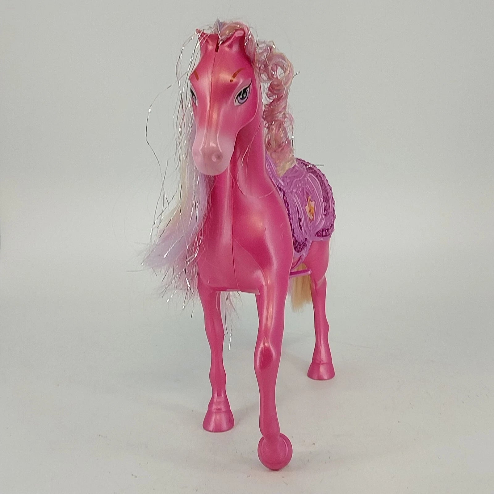 Pink Disney Princess horse toy with blonde mane and purple saddle