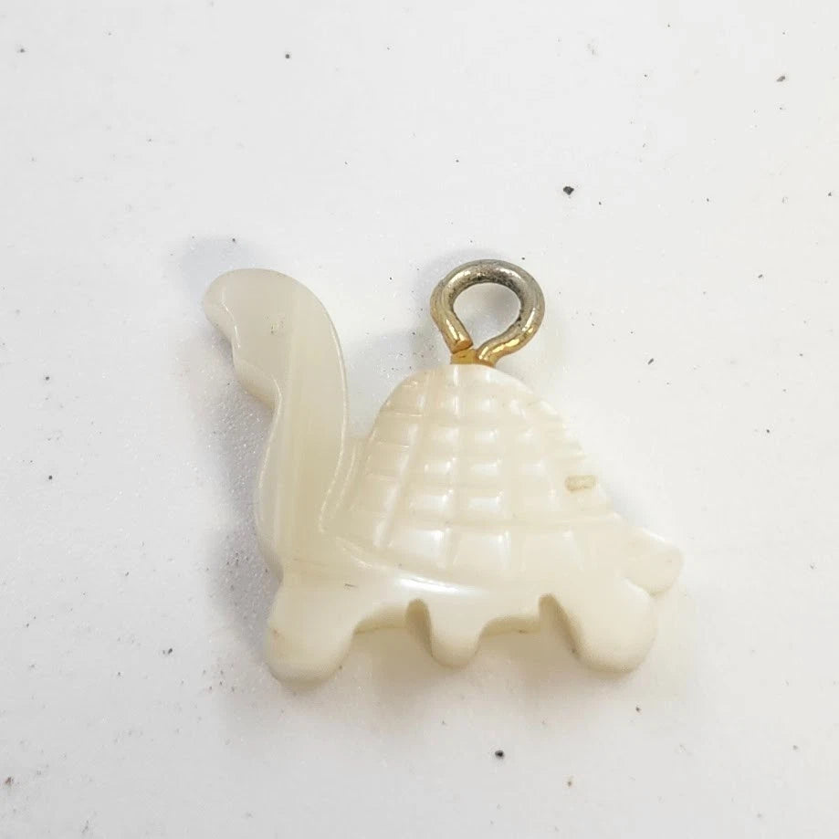 Small natural mother of pearl turtle charm with gold-tone jump ring