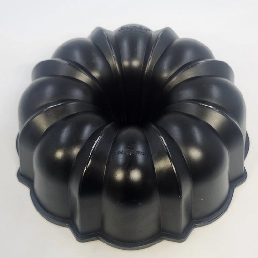 Black Nordic Ware 12-cup Bundt cake pan with deep fluted design